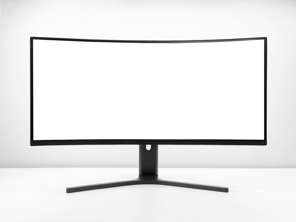 a white monitor with a black stand